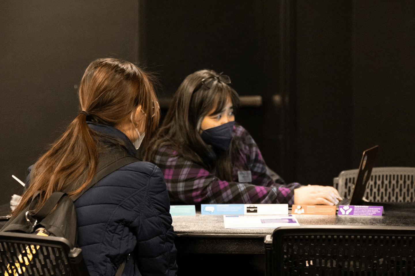 Two people at a desk at the career fair