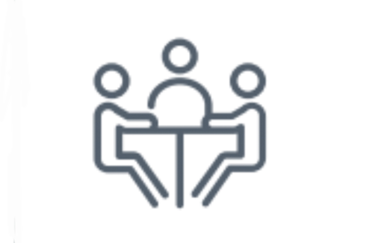 Three human stick figures sit at a table